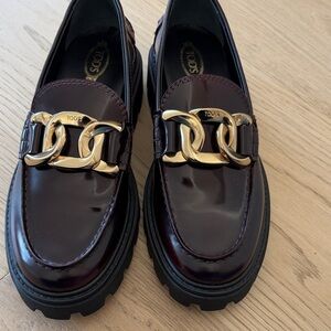 Tod's Dark Burgundy Loafers with Gold Chain Detail